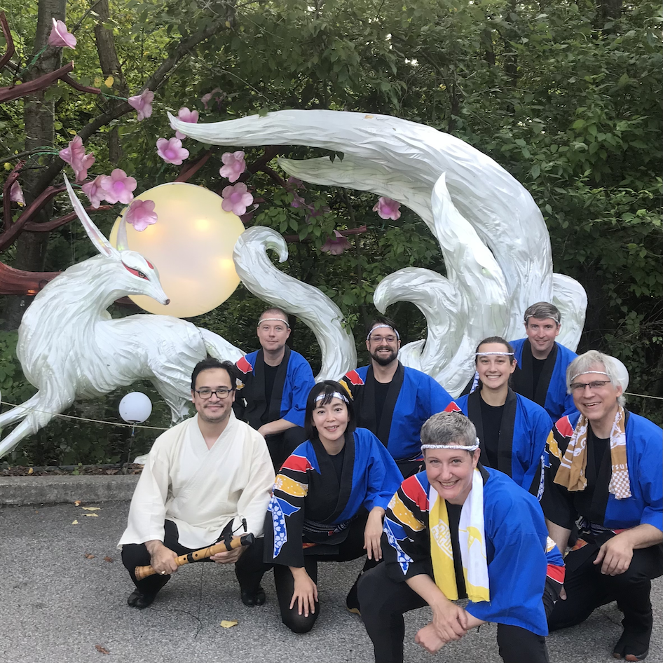 Pittsburgh Taiko performers pose in front of a nine-tailed fox lantern at Pittsburgh Zoo on August 13 2021.